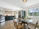 Modern kitchen with stainless steel appliances, tile backsplash, and eat-in breakfast nook with table at 207 Iowa Dr, Golden, CO 80403