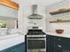 Modern kitchen features stainless steel appliances and bright white subway tile backsplash at 207 Iowa Dr, Golden, CO 80403