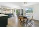 Modern kitchen with stainless steel appliances, tile backsplash, and eat-in breakfast nook with table at 207 Iowa Dr, Golden, CO 80403
