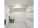 Bright laundry room featuring tile flooring, utility sink, and wire shelving at 207 Iowa Dr, Golden, CO 80403