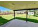 The spacious backyard features a lush lawn, storage shed, and a covered patio area, perfect for outdoor entertaining at 3026 S Alton Ct, Denver, CO 80231