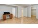 Finished basement with a desk and multiple doors leading to other rooms at 3026 S Alton Ct, Denver, CO 80231