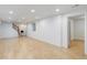 Finished basement featuring light wood floors and access to stairs at 3026 S Alton Ct, Denver, CO 80231