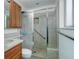 Updated bathroom features a tiled walk-in shower with sliding glass doors at 3026 S Alton Ct, Denver, CO 80231