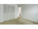 Bedroom featuring neutral carpet, white walls, and a large closet with folding doors at 3026 S Alton Ct, Denver, CO 80231