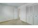 Bedroom with neutral carpet, white walls, and a closet for storage at 3026 S Alton Ct, Denver, CO 80231