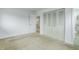 Spacious bedroom featuring neutral carpet, a large closet, and an ensuite bathroom for added convenience at 3026 S Alton Ct, Denver, CO 80231