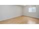 Finished basement bedroom featuring light wood floors and window at 3026 S Alton Ct, Denver, CO 80231