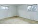 Bedroom with neutral carpet, white walls, and natural light from two windows at 3026 S Alton Ct, Denver, CO 80231