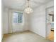 Dining room featuring window, chandelier and access to kitchen at 3026 S Alton Ct, Denver, CO 80231