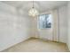 Bright dining room features a chandelier and a window with neutral-toned curtains at 3026 S Alton Ct, Denver, CO 80231