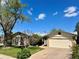 Charming single-Gathering home featuring a well-maintained lawn, mature trees, and attached two-car garage at 3026 S Alton Ct, Denver, CO 80231