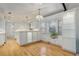 Open kitchen with hardwood floors, white cabinets, and a cozy window nook at 3026 S Alton Ct, Denver, CO 80231