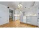Open kitchen featuring glass front cabinets, modern appliances, and hardwood floors at 3026 S Alton Ct, Denver, CO 80231