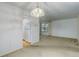 Living room with carpeted floor, white walls, and refrigerator at 3026 S Alton Ct, Denver, CO 80231