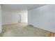 Spacious living room with neutral carpet, white walls, and a view into adjacent rooms at 3026 S Alton Ct, Denver, CO 80231