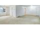 Carpeted living room with bright light fixture at 3026 S Alton Ct, Denver, CO 80231