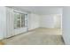 Bright living room features large windows, neutral carpet, and white walls at 3026 S Alton Ct, Denver, CO 80231