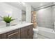 Well-lit bathroom featuring modern fixtures, shower-tub combo, and decorative accents at 4394 Zenobia St, Denver, CO 80212