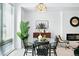 Dining room with a clear table, pendant lighting and big window provides a modern and inviting dining experience at 4394 Zenobia St, Denver, CO 80212