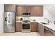 Modern kitchen features stainless steel appliances, white countertops, and stylish wood cabinetry for a sleek design at 4394 Zenobia St, Denver, CO 80212