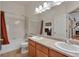 Well-lit bathroom features a double sink vanity, bathtub, and contemporary fixtures at 7211 Dolomite Ln, Castle Rock, CO 80108