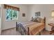 Serene bedroom featuring a wrought iron bed and a large window with scenic outdoor views at 7211 Dolomite Ln, Castle Rock, CO 80108