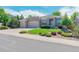 Charming single-story home with manicured lawn, brick exterior, and a two-car garage at 7211 Dolomite Ln, Castle Rock, CO 80108