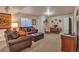 Basement living room boasts a comfortable leather sofa and a charming dining space at 7211 Dolomite Ln, Castle Rock, CO 80108