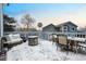 Spacious snowy back deck with outdoor seating, a table, and a fire pit; ideal for entertaining at 4286 S Cole St, Morrison, CO 80465