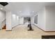 Open basement area with an elliptical machine and walkout access, offering space for fitness and recreation at 4286 S Cole St, Morrison, CO 80465