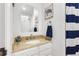 Bright bathroom featuring a granite countertop, a vanity, and nautical decor, offering a fresh and stylish space at 4286 S Cole St, Morrison, CO 80465