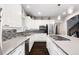 Well-appointed kitchen with stainless steel appliances, modern backsplash, and quartz countertops at 4286 S Cole St, Morrison, CO 80465