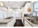 Bright kitchen featuring white cabinets, stainless appliances, and quartz countertops at 4286 S Cole St, Morrison, CO 80465