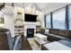 Cozy living room features a fireplace with marble surround, built-in shelving and lots of natural light at 4286 S Cole St, Morrison, CO 80465