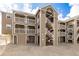 Multi-level exterior view showing the light brown siding and stairs leading to the units at 1273 S Gilbert St # A103, Castle Rock, CO 80104