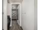 Hallway with a door to the laundry, a door, and white walls and trim at 1273 S Gilbert St # A103, Castle Rock, CO 80104