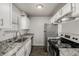 Bright kitchen featuring granite countertops, stainless steel appliances, and white cabinetry at 1273 S Gilbert St # A103, Castle Rock, CO 80104