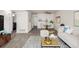 Open-concept living area with modern furnishings, wood-look floors, and integrated dining space at 1273 S Gilbert St # A103, Castle Rock, CO 80104