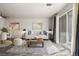 Bright living room with modern furniture, a decorative rug, and a sliding door to a balcony at 1273 S Gilbert St # A103, Castle Rock, CO 80104