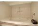 Relaxing bathroom with a large soaking tub surrounded by tiled walls at 7255 E Quincy Ave # 403, Denver, CO 80237