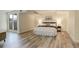 Spacious bedroom featuring wood-look floors, large bed, and ample natural light at 7255 E Quincy Ave # 403, Denver, CO 80237