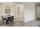 Dining area featuring wood-look floors, contemporary chandelier, and view into kitchen at 7255 E Quincy Ave # 403, Denver, CO 80237