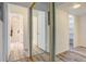 Hallway with closet doors and a view into the kitchen and bath area, well lit at 7255 E Quincy Ave # 403, Denver, CO 80237