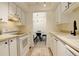 Functional kitchen with white cabinets, complementing countertops, and a clear view into the dining area at 7255 E Quincy Ave # 403, Denver, CO 80237