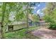 Backyard area with a brick patio, grassy areas, and mature aspen trees at 1324 Virginia St, Idaho Springs, CO 80452