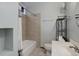 Neutral bathroom featuring a shower-tub, toilet, and sink, complemented by a rack for storage at 1324 Virginia St, Idaho Springs, CO 80452