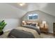 Cozy bedroom featuring paneled walls, window with mountain views, and coordinated decor at 1324 Virginia St, Idaho Springs, CO 80452