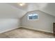 A simply decorated bedroom with paneled walls and a window offering mountain views at 1324 Virginia St, Idaho Springs, CO 80452