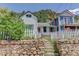 Charming two-story house featuring a cozy porch and a bright red door, framed by a rustic stone retaining wall at 1324 Virginia St, Idaho Springs, CO 80452